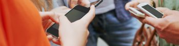 People on their phones. Learn more about quitting tobacco.
